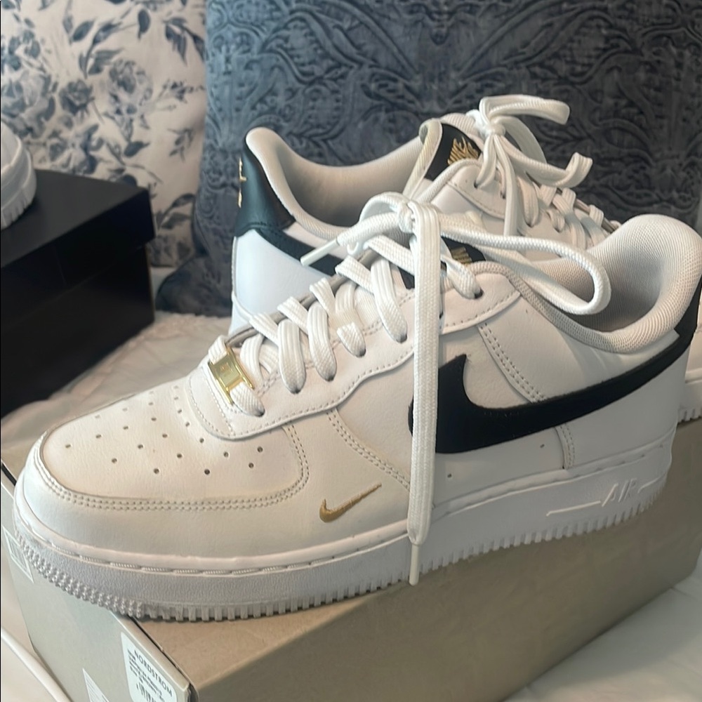 Nike White Sneakers with Black Swoosh and Gold Details